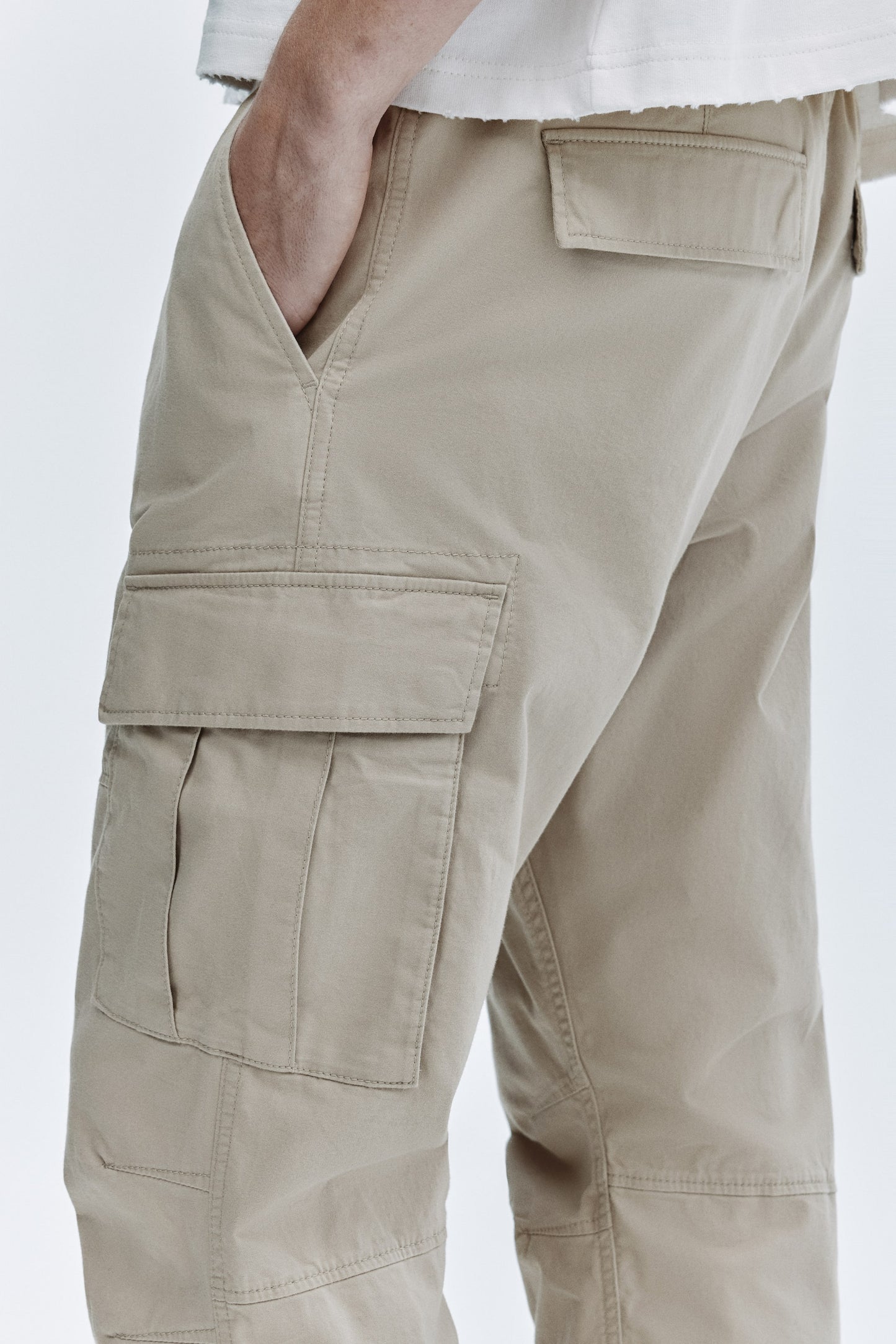 Beige cargo pants on a white background