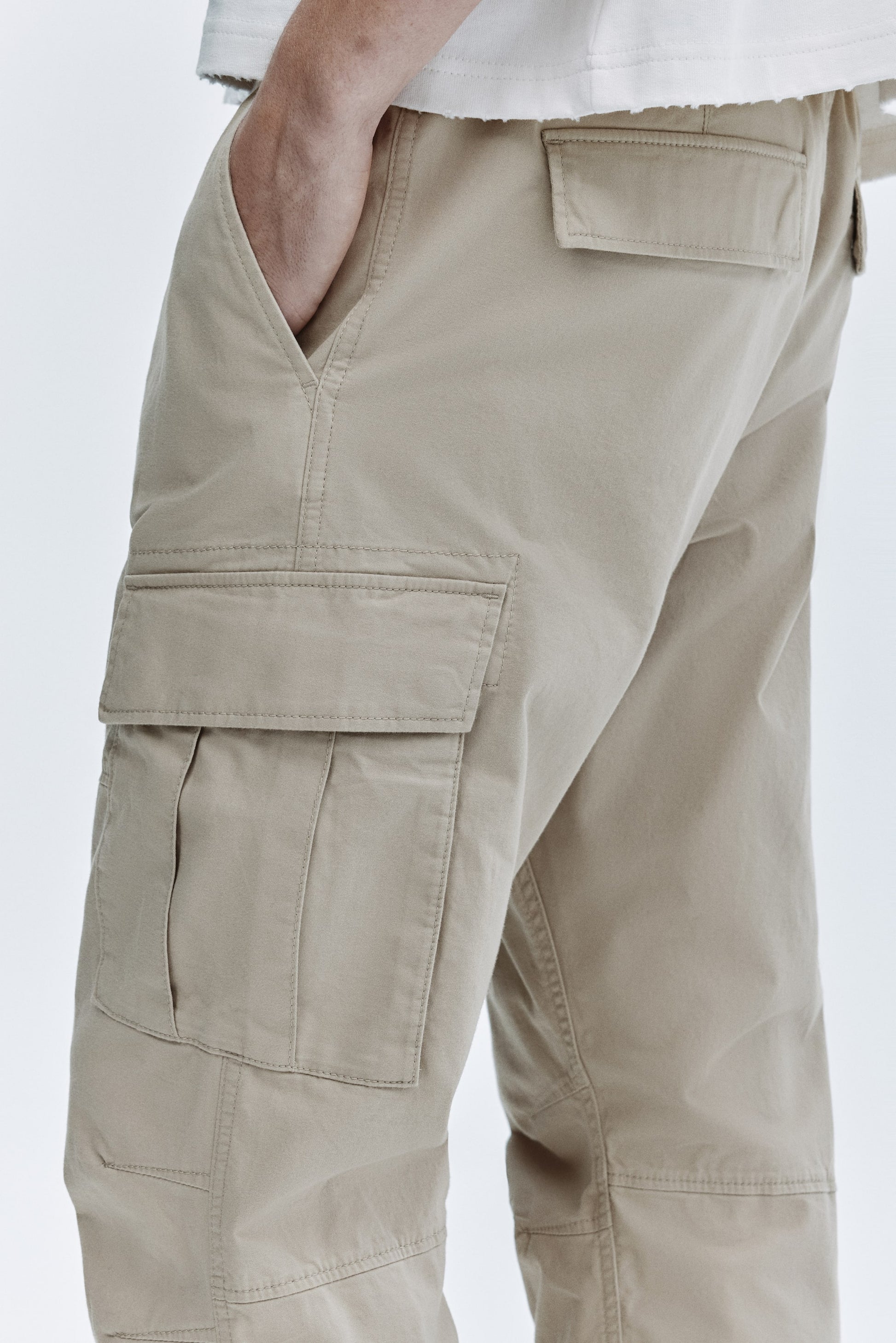 Beige cargo pants on a white background