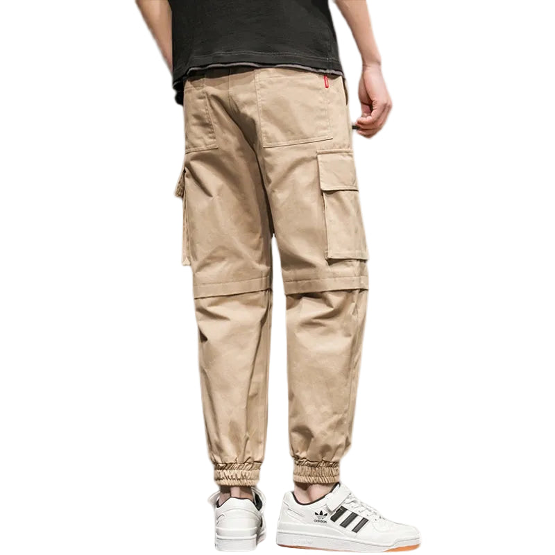 Beige cargo pants worn by a person on a white background