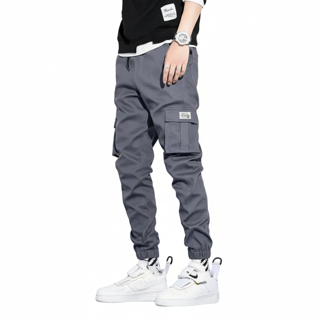 Gray cargo pants worn by a person on a white background