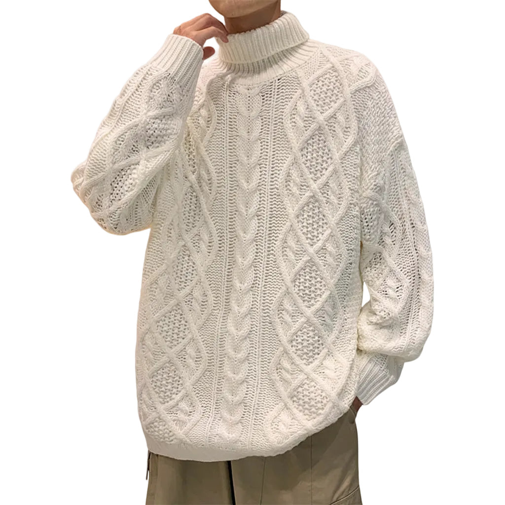 White cable knit sweater worn by a person on a white background