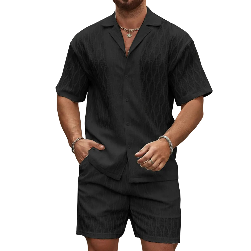 Man wearing a black short-sleeve shirt and shorts set on a white background