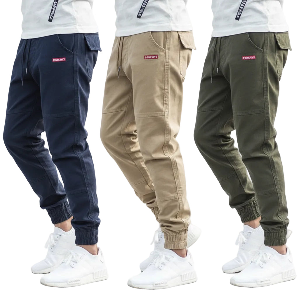 Three pairs of jogger pants in navy, beige, and green with white sneakers on a white background.