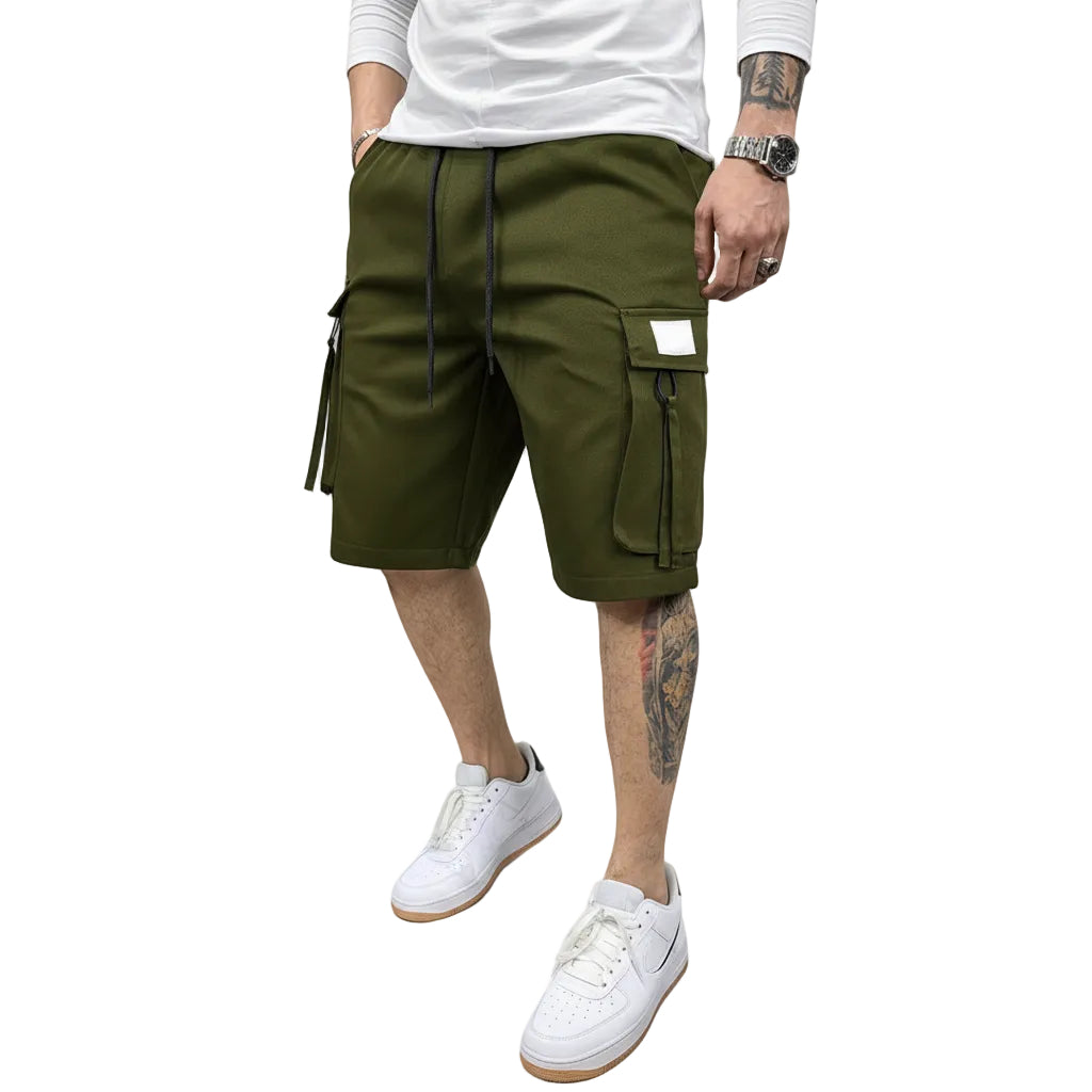 Person wearing olive green cargo shorts on a white background